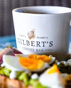 A cup of coffee with avocado toast and egg sandwich 